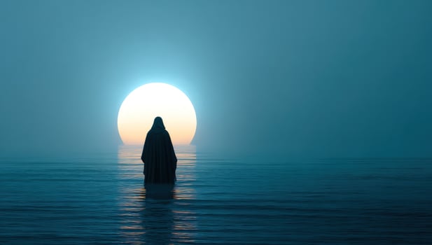 Robed figure stands in the water against a large, bright sun over the horizon photo