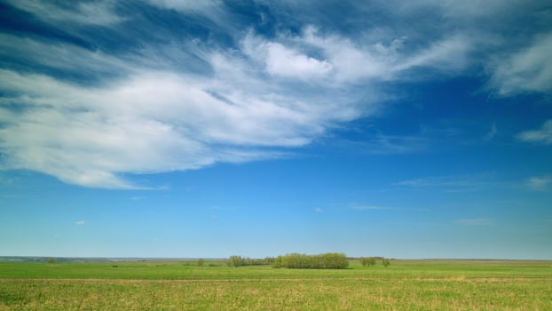 The Beautiful and Serene Countryside Featuring a Bright Blue Sky with Fluffy White Clouds photo