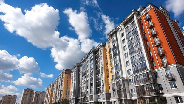A row of apartment buildings with a blue sky in the background photo