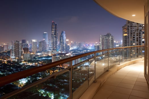 Balcony view of city skyline at night. Urban lights in background, travel photo