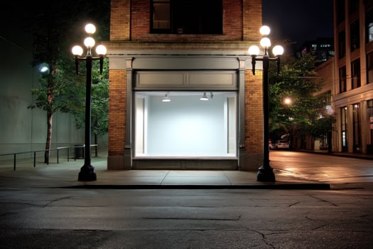 Empty store front at night with bright light, background city for sale or rent photo