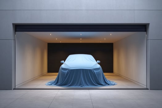 Car under cover in garage for unveiling or storage. Showroom with spotlights photo