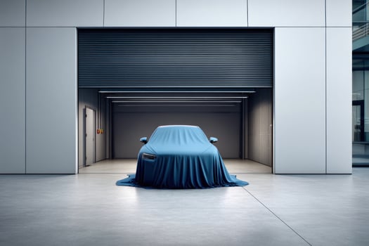 Car reveal event in large garage with cloth drape. Background window light photo