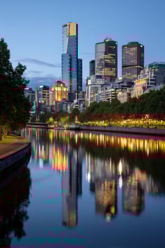 City skyline reflected on river at night. Travel, cityscape background scene photo