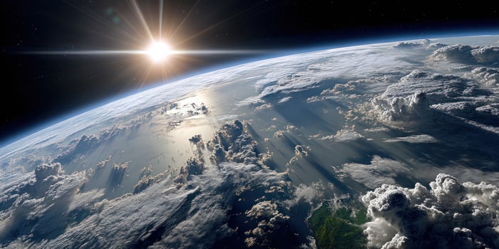 Earth seen from space, sun shining over cloudscape, serene planet, orbit photo