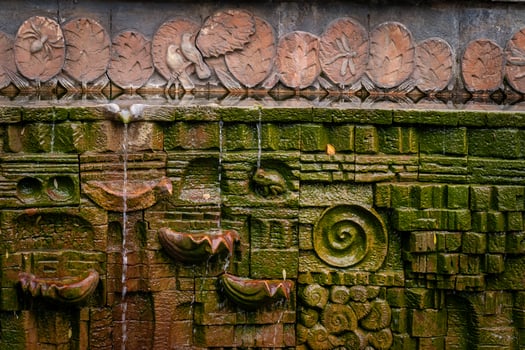 Intricate Stone Carving with Flowing Water Stream photo