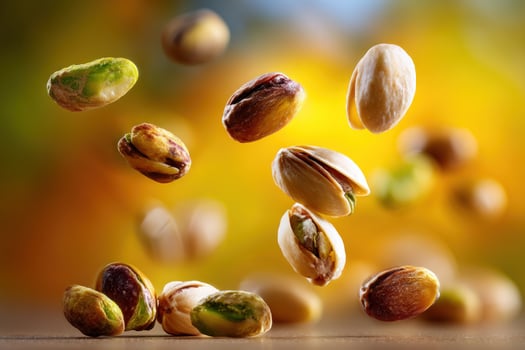 Pistachios fall on table, food art, delicious background, recipe, food advertising photo