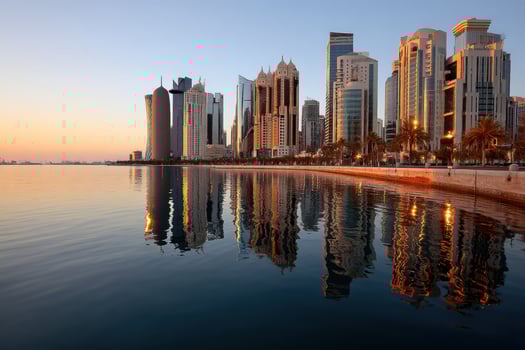 Skyline reflects off the water at sunset on the coast of a busy financial district photo