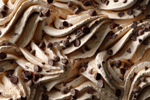 Swirls of caramel ice cream with chocolate chips, close up, dessert texture photo