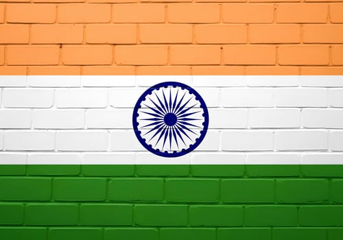 Flag of India painted on a brick wall. The flag consists of three horizontal stripes saffron at the top, white in the middle, and green at the bottom. photo