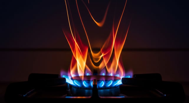 Fiery Crown of Blue and Orange Gas Flames Ignited on a Stove Top photo