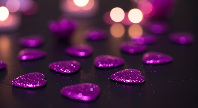 Purple hearts on a black background with candles photo
