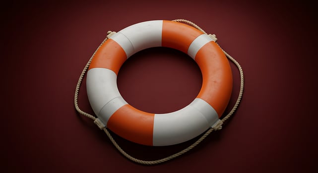 Solitary Orange and White Lifebuoy Poised Against a Deep Maroon Background photo