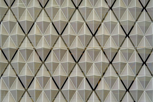 The building dimensional facade. Beautiful symmetrical diamond pattern. photo