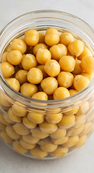 A glass jar filled with yellow beans photo
