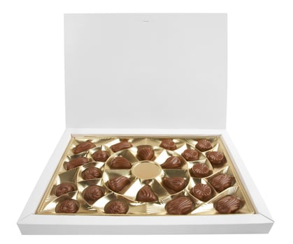 Box with chocolates on white photo