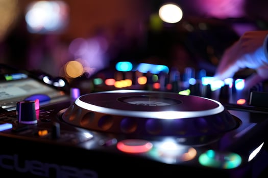 Close-up of dj mixing console with vibrant led lights, dynamic music production equipment for nightclub visuals photo