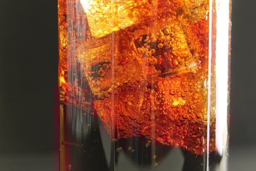 macro drink kvass with ice close-up bubbles in drink soda on a dark black background photo
