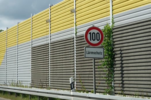 Tall noise barrier and speed limit sign on highway at A7 near Hamburg photo