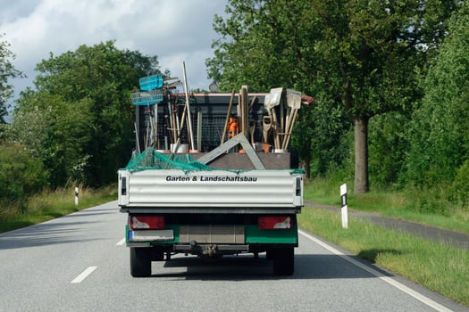 Loaded truck with garden tools on two lane road photo