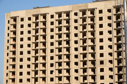 A Modern Building is Under Construction featuring Open Windows and an Exposed Concrete Structure photo