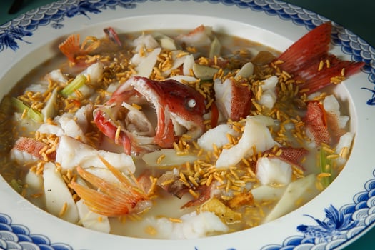 Fish Head Tofu Soup in Broth features tender fish pieces, silky tofu closeup view of Asian Seafood photo