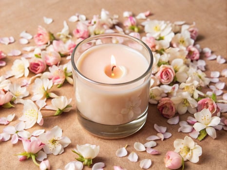 a candle surrounded by pink flowers photo
