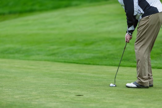 Golf Player Putting Ball on Green Field Closeup Outdoor Sports Action Professional Game or Training photo