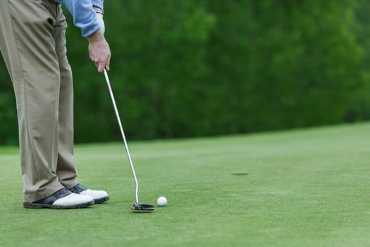 Golf Player Putting Ball on Green Field Closeup Outdoor Sports Action Training Game or Tournament photo