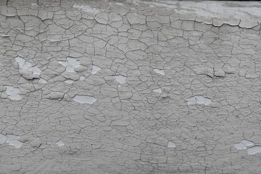 Close-up of weathered and cracked concrete wall surface texture photo