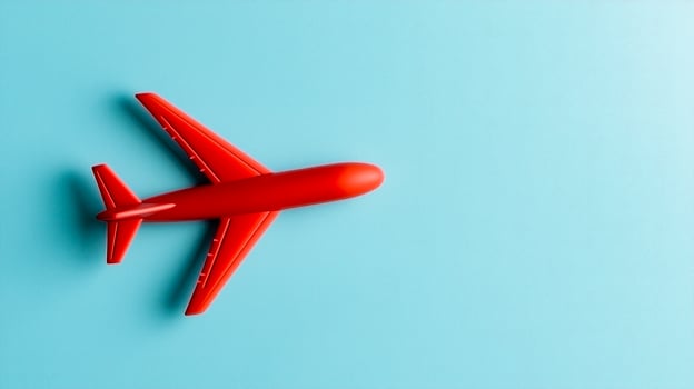 A red toy airplane on a blue background photo