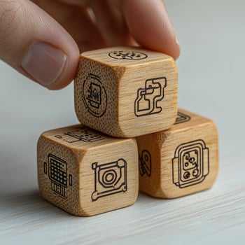 Stacked Wooden Blocks Displaying Smart Home Automation and IoT Device Icons, Hand Holding Top Block, Innovation and Technology photo