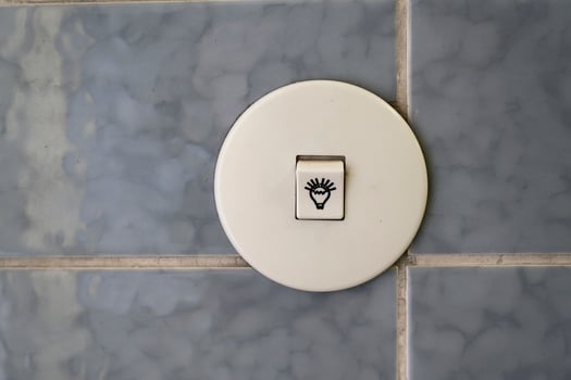 Vintage white light switch on blue tiles photo