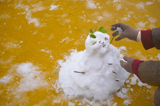 Building a snowman in a colorful winter wonderland photo