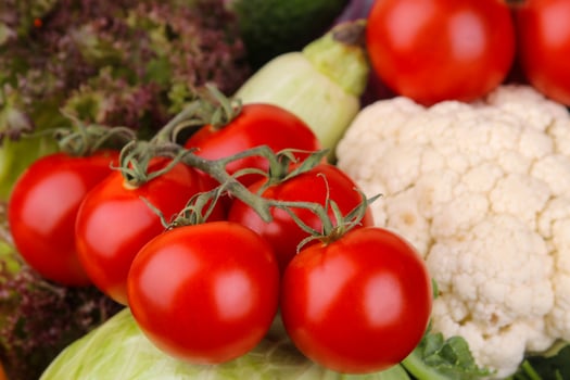 Different vegetables including tomatoes, zucchini, cauliflower and lettuce close-up. Background photo