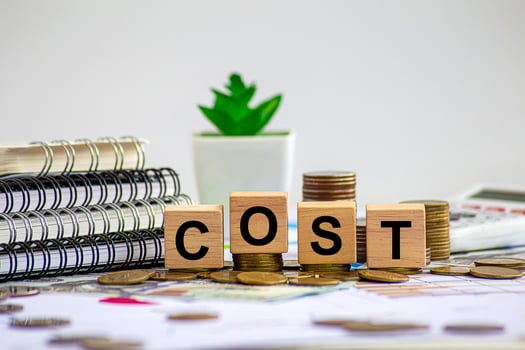 Cost reduction concept. Cost wording on decreasing coins stacking. cost reduction concept which effect to product cost , profit , inflation and economy recession concept. photo