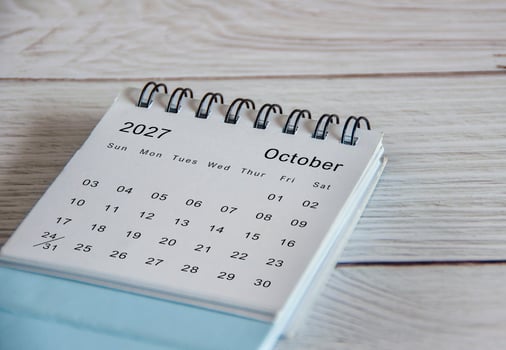 Close up of October 2027 calendar on wooden background photo