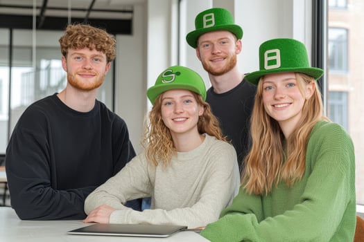 Creative team celebrating St. Patrick Day with green hats and smiles photo