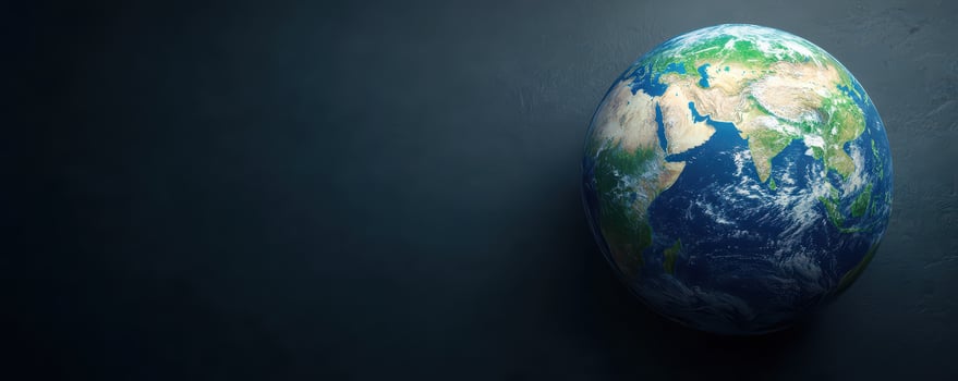 Earth globe with visible continents and ocean on dark background, symbolizing planet and environment photo