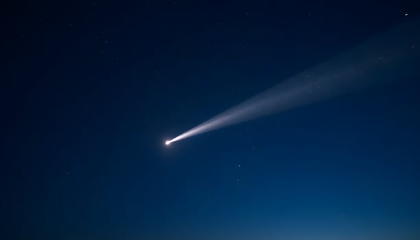 Beacon in the Night A Beam of Light Against a Starry Sky photo