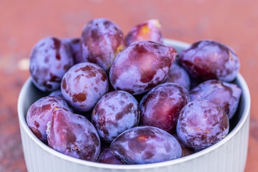 Fresh plums picked from the garden. Plate with vitamins photo