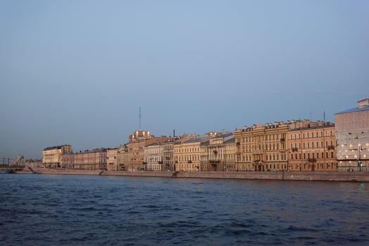 A Scenic Riverfront View Showcasing Beautiful Historic Buildings and Surrounding Nature photo