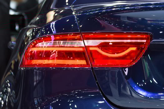 A close up of the tail lights of a blue car photo
