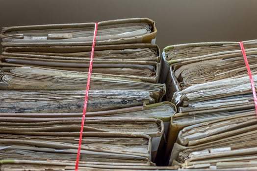 A stack of old documents with red tape photo