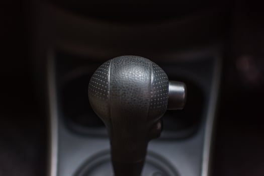 Car interior with gear stick and sport button photo