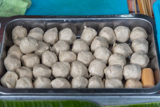 A tray of food with a banana leaf on top photo
