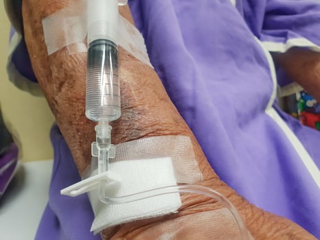 A person with a drip on their arm photo