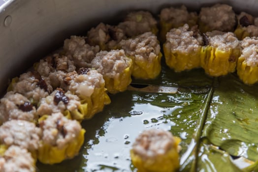 A pan filled with meat and vegetables being cooked photo