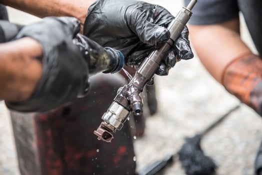 A person is holding a wrench and cleaning it photo