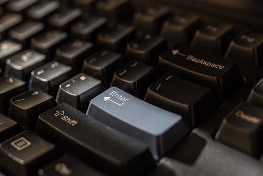 A close up of a computer keyboard with a blue button photo